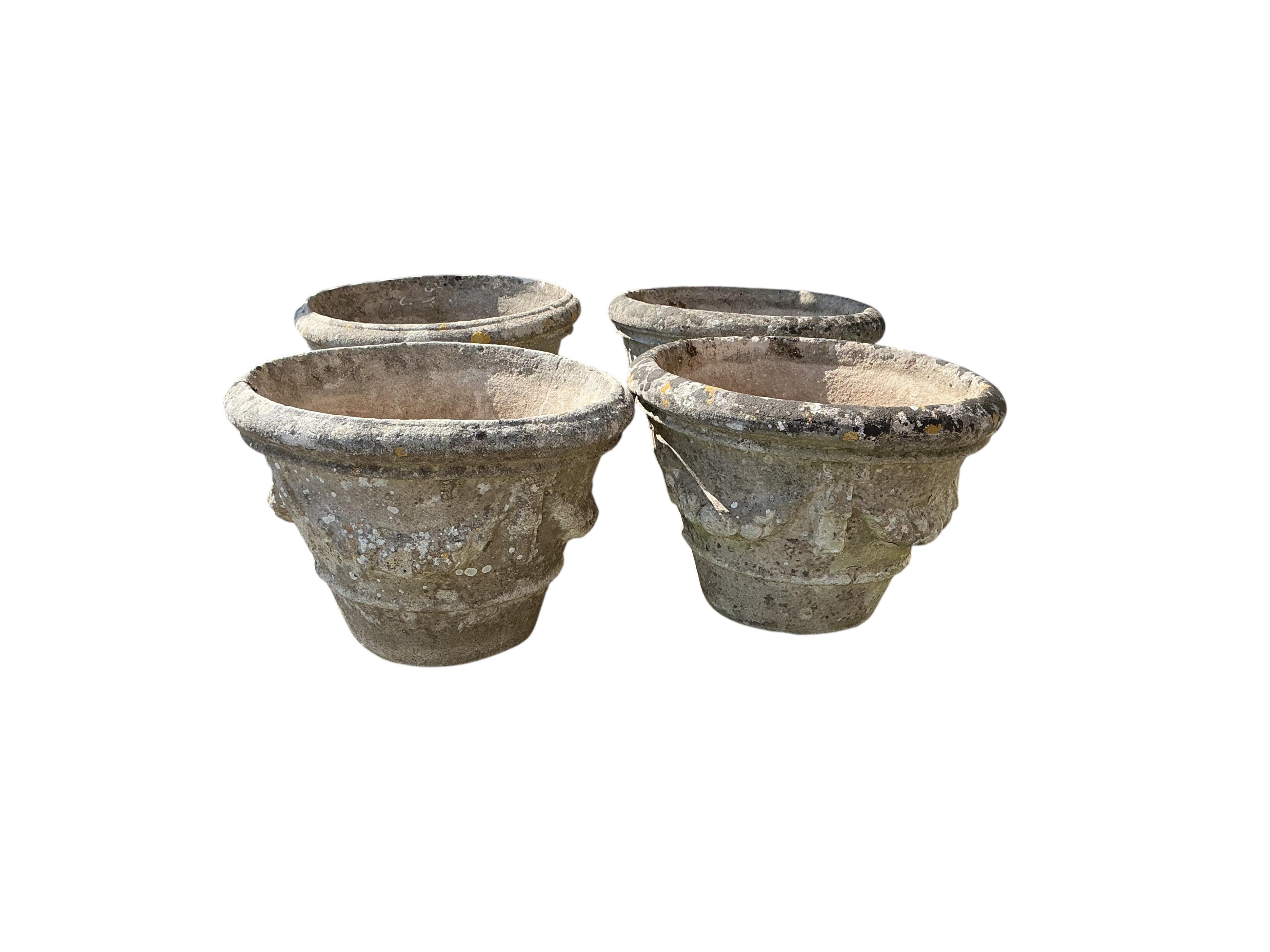 A set of four circular reconstituted stone garden planters, diameter 49cm, height 34cm